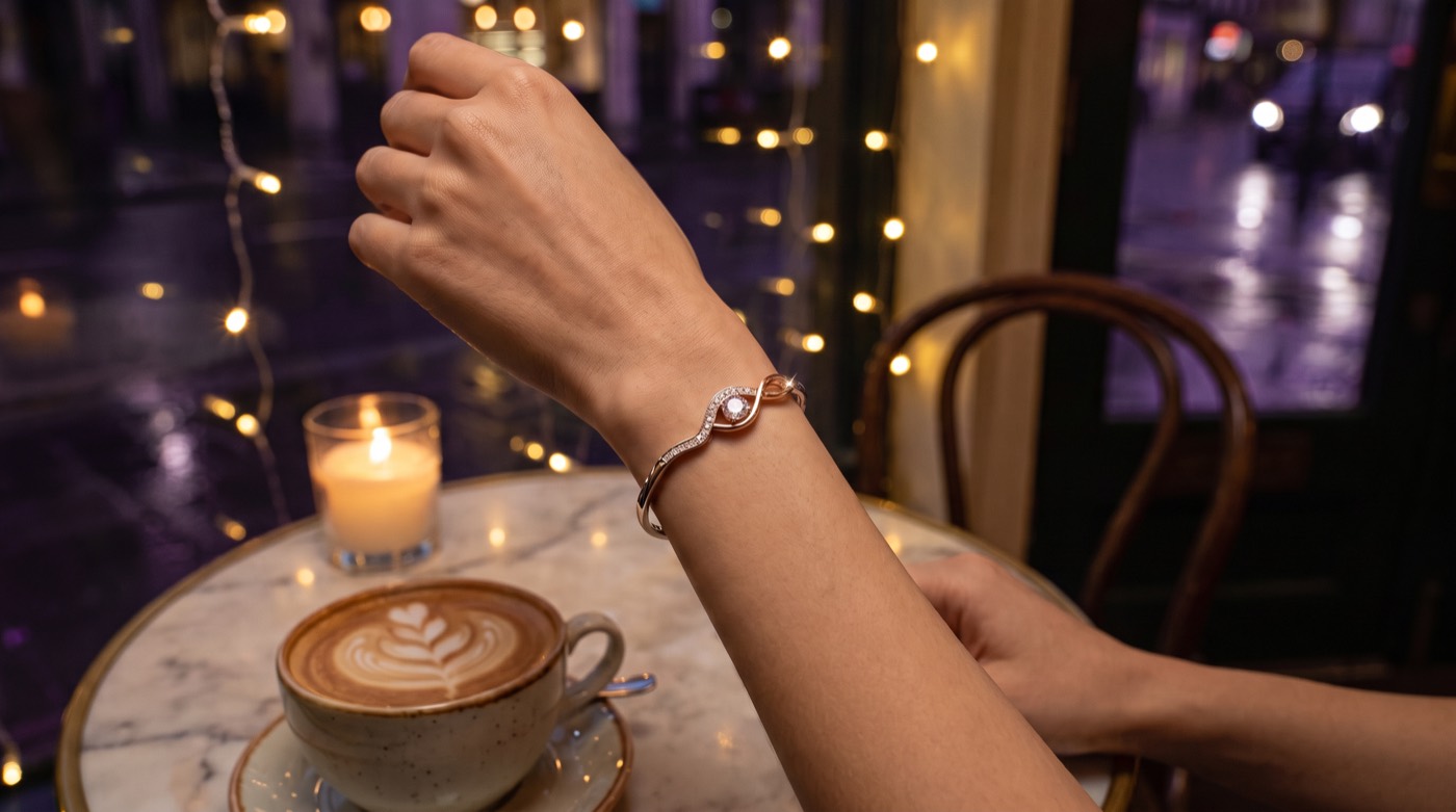 A bracelet fastened beside a coffee on a rainy evening